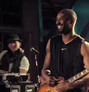 djvinom-kobe-bryant dj vinom and kobe bryant on stage with a guitar